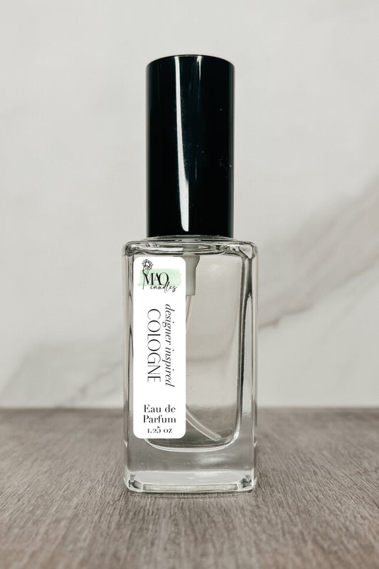 Clear perfume bottle with black cap on a wooden surface